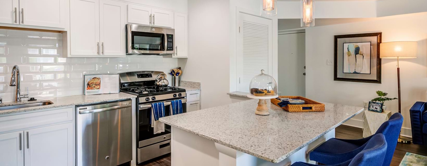 Kitchen with small island and pendent lighting.